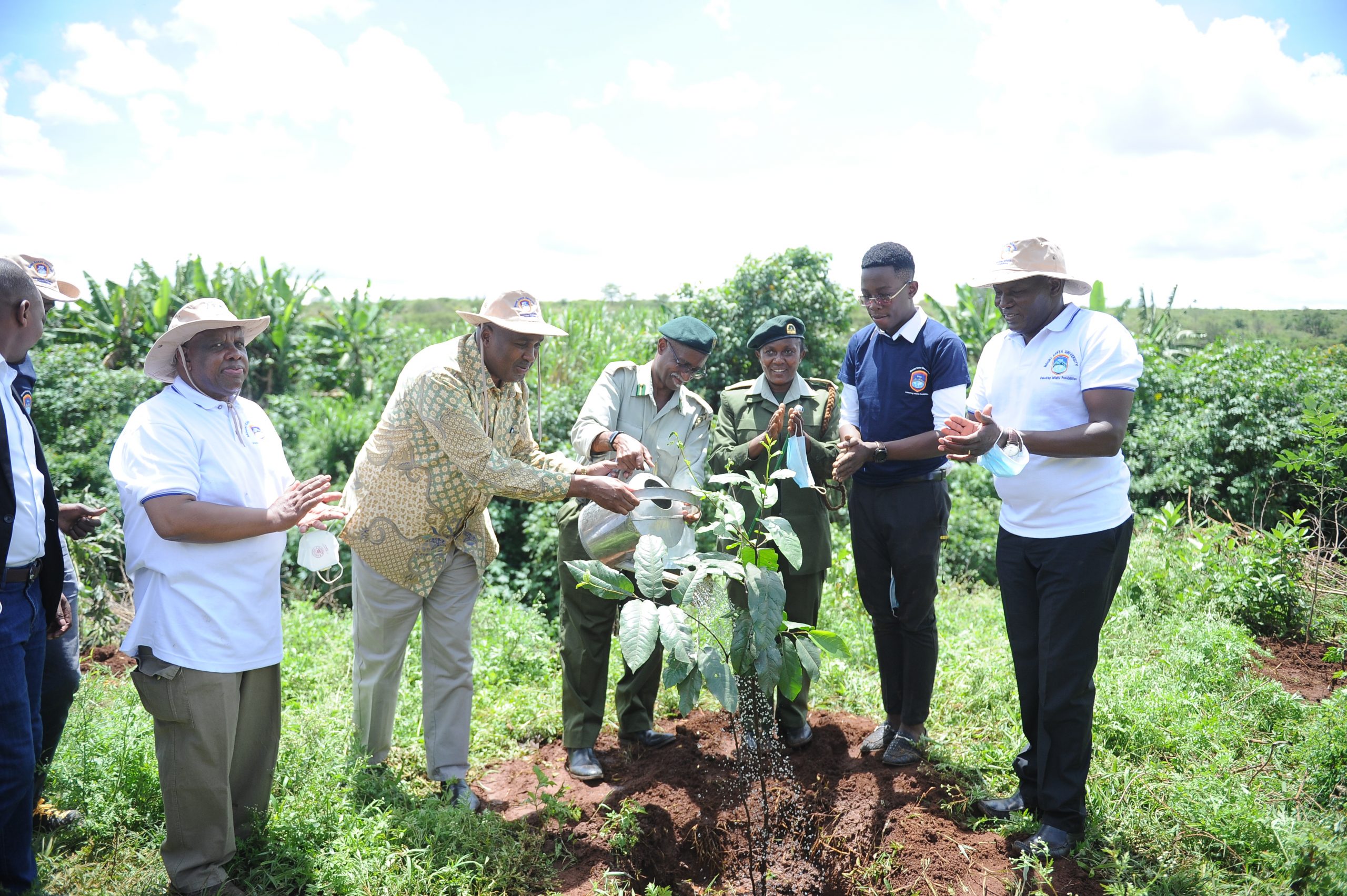 MKU staff, KFS officers plant a tree during Mount Kenya University's botanic tree planting ceremony